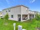 Home featuring a covered patio, grill, and well-maintained lawn at 1042 Lido Dr, Howey In The Hills, FL 34737