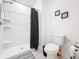 Bathroom featuring a white tile shower, toilet, and neutral walls at 1042 Lido Dr, Howey In The Hills, FL 34737