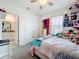 Bedroom featuring carpet, a ceiling fan, a bed, and a view into the bathroom at 1042 Lido Dr, Howey In The Hills, FL 34737