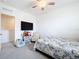 Bedroom with a ceiling fan, carpet, a TV, and a small storage area at 1042 Lido Dr, Howey In The Hills, FL 34737