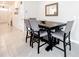 Cozy dining area with a wooden table and upholstered chairs, creating a comfortable space for meals and gatherings at 1042 Lido Dr, Howey In The Hills, FL 34737