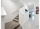 Bright entryway with tile floors and staircase leading to the upper level of the home at 1042 Lido Dr, Howey In The Hills, FL 34737