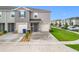 Well-maintained home featuring a one-car garage, blue door, and a neatly landscaped front yard at 1042 Lido Dr, Howey In The Hills, FL 34737