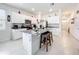 Well-lit kitchen boasts granite countertops, stainless appliances, and a functional center island with seating at 1042 Lido Dr, Howey In The Hills, FL 34737