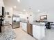 Bright kitchen features stainless appliances, granite counters, and a center island with seating at 1042 Lido Dr, Howey In The Hills, FL 34737