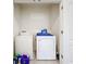 Laundry room features white washer and dryer appliances, with detergent and cleaning supplies at 1042 Lido Dr, Howey In The Hills, FL 34737