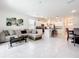 Open concept living space featuring tile flooring, a comfortable sofa, and a kitchen with a breakfast bar at 1042 Lido Dr, Howey In The Hills, FL 34737