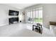 Neutral-toned living room with a large sliding glass door that provides natural light and access to the outdoor area at 1042 Lido Dr, Howey In The Hills, FL 34737