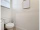 Half-bathroom with toilet and framed art piece containing bathroom rules at 1042 Lido Dr, Howey In The Hills, FL 34737