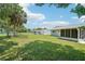 Large backyard featuring a well-maintained lawn and a screened-in porch at 11214 Sw 77Th Ct, Ocala, FL 34476