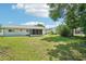 This backyard features a screened in patio and lush green grass at 11214 Sw 77Th Ct, Ocala, FL 34476