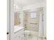 Well-lit bathroom includes a shower-tub combo and a mirrored vanity with storage at 11214 Sw 77Th Ct, Ocala, FL 34476