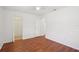 This bedroom boasts hardwood floors, white walls, ceiling fan, and closet at 11214 Sw 77Th Ct, Ocala, FL 34476