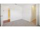 Bright bedroom features neutral carpet, white walls, and convenient access to bathroom and closet at 11214 Sw 77Th Ct, Ocala, FL 34476