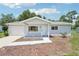 Charming single-story home featuring a cozy front porch and attached garage at 11214 Sw 77Th Ct, Ocala, FL 34476