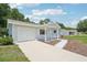 Single-story home with attached garage and cozy front porch at 11214 Sw 77Th Ct, Ocala, FL 34476