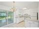 Bright eat-in kitchen with white cabinetry, modern appliances, and tile flooring at 11214 Sw 77Th Ct, Ocala, FL 34476