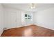 Bright living room with hardwood floors, white walls, and natural light at 11214 Sw 77Th Ct, Ocala, FL 34476