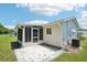 Rear exterior with a screened porch addition, patio, and neutral vinyl siding at 11214 Sw 77Th Ct, Ocala, FL 34476