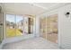 Tiled sunroom features multiple windows and a sliding door, providing backyard access and natural light at 11214 Sw 77Th Ct, Ocala, FL 34476