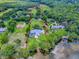 Expansive lakefront property with a beautiful lawn, mature trees, and property line highlighted in red at 11226 Lane Park Rd, Tavares, FL 32778