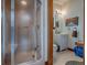 Bathroom with a modern glass shower, a white vanity with a sink, and a wooden-framed mirror at 11226 Lane Park Rd, Tavares, FL 32778