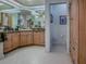 Bright bathroom features custom cabinetry, marble countertop, and tiled flooring at 11226 Lane Park Rd, Tavares, FL 32778