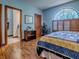 Serene bedroom with an en-suite bathroom, a quilt-covered bed, and an arched window at 11226 Lane Park Rd, Tavares, FL 32778