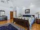 Bedroom showcases wood floors, vaulted ceilings and traditional furnishings including a four-poster bed at 11226 Lane Park Rd, Tavares, FL 32778