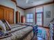 Comfortable bedroom featuring wood floors, closet, dresser and an outdoor view at 11226 Lane Park Rd, Tavares, FL 32778