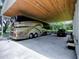 Spacious carport with a RV, wooden beam ceiling, and additional parking at 11226 Lane Park Rd, Tavares, FL 32778