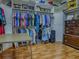 Walk-in closet features built-in shelving, ample hanging space, and wooden floors at 11226 Lane Park Rd, Tavares, FL 32778