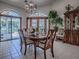 Elegant dining room featuring a decorative chandelier, tile flooring, and plenty of natural light from the French doors at 11226 Lane Park Rd, Tavares, FL 32778