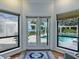 Doors provide seamless access to the screened pool area and the beautiful lake beyond at 11226 Lane Park Rd, Tavares, FL 32778