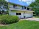 Charming two-story home with an attached garage and well-maintained lawn at 11226 Lane Park Rd, Tavares, FL 32778