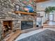 Close-up of a stone fireplace with hearth, wooden mantel, and decorative elements on display at 11226 Lane Park Rd, Tavares, FL 32778