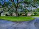 Expansive home with mature trees and lush landscaping, set back from a circular driveway at 11226 Lane Park Rd, Tavares, FL 32778