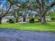 Spacious home featuring a well-manicured lawn and large shade trees at 11226 Lane Park Rd, Tavares, FL 32778