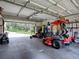 Spacious garage with high ceilings, ample storage space, and yard equipment at 11226 Lane Park Rd, Tavares, FL 32778