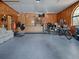 Spacious garage featuring wood paneled walls, ample storage, and room for multiple vehicles and recreational equipment at 11226 Lane Park Rd, Tavares, FL 32778