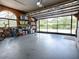 Large garage featuring an open door with view to the outdoors, as well as ample storage along the walls at 11226 Lane Park Rd, Tavares, FL 32778