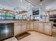 Open kitchen features granite countertops, stainless steel appliances, tile floor, and breakfast bar with skylights at 11226 Lane Park Rd, Tavares, FL 32778