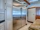 The bright kitchen features a large stainless steel refrigerator and custom cabinetry at 11226 Lane Park Rd, Tavares, FL 32778