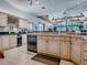 Bright kitchen features granite countertops, stainless steel appliances, wine rack, and breakfast bar with skylights at 11226 Lane Park Rd, Tavares, FL 32778