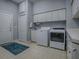 Well-organized laundry room features matching washer and dryer, ample storage, and a convenient utility sink at 11226 Lane Park Rd, Tavares, FL 32778