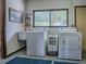 Functional laundry room with a washer, dryer, and utility sink for added convenience at 11226 Lane Park Rd, Tavares, FL 32778