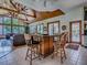 Inviting living area with wood-clad vaulted ceiling, large picture windows, and an island with seating at 11226 Lane Park Rd, Tavares, FL 32778