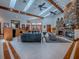 Spacious living room with stone fireplace, high ceilings, skylights, and an open floor plan at 11226 Lane Park Rd, Tavares, FL 32778