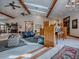 Elegant living room with high ceilings, wood beams, and stylish decor, adjacent to dining area at 11226 Lane Park Rd, Tavares, FL 32778