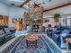 Living room with stone fireplace, wood beams, and comfortable seating area with stylish decor at 11226 Lane Park Rd, Tavares, FL 32778